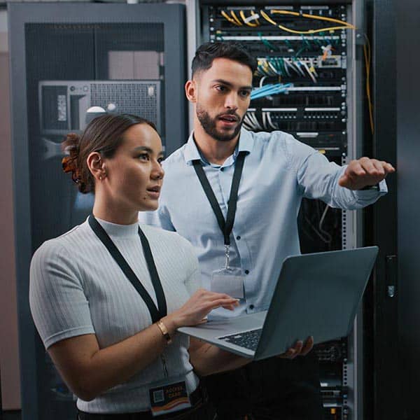 Shot of two colleagues working together in a server room